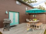 Off the kitchen is the backyard. The deck has seating and a BBQ.